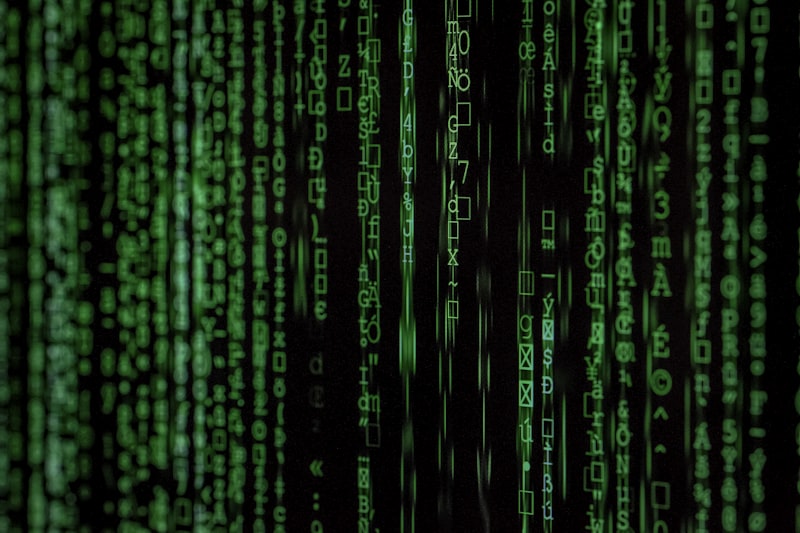 Prompt: Macro shot of a dark computer screen displaying glowing neon green hacker code, matrix aesthetic, cyber security concept, 4k